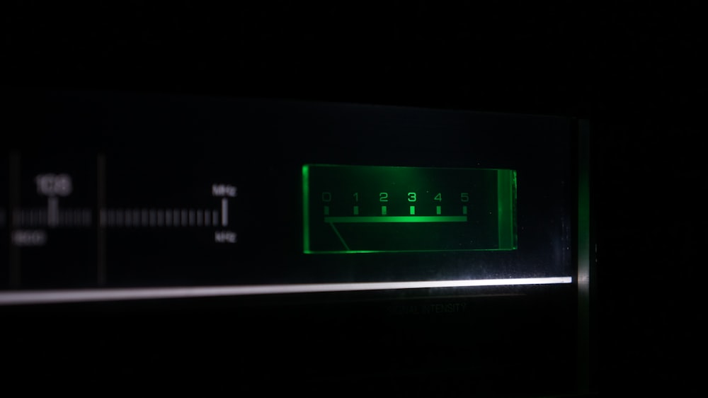 a close up of a green light in a dark room