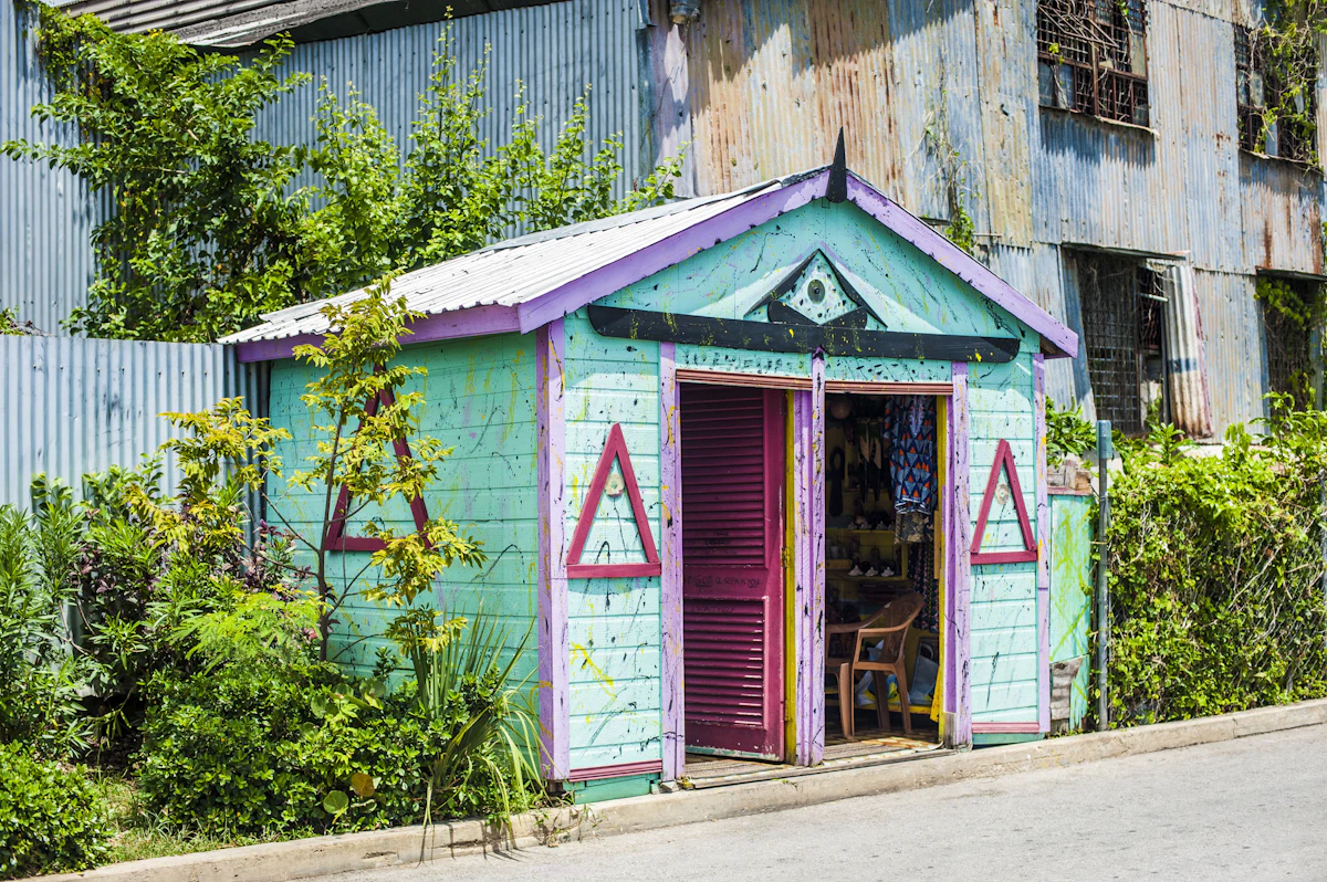 A brightly painted Bajan chattel-style building with a purple door, the kind of small-scale local craftsmanship CXC's coursework system was originally built to assess