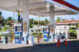 a gas station with a man on a ladder