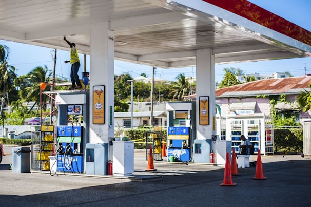 a gas station with a man on a ladder