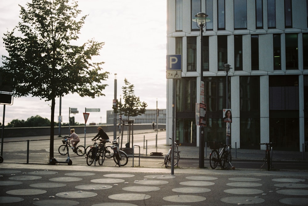 a couple of people riding bikes down a street