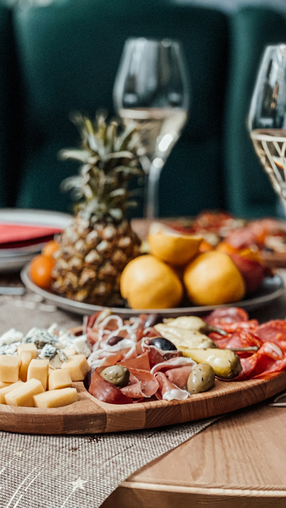 a table topped with plates of food and glasses of wine