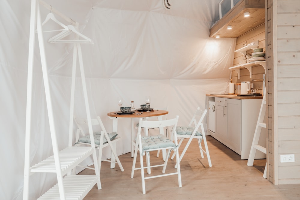 a kitchen area with a table and chairs