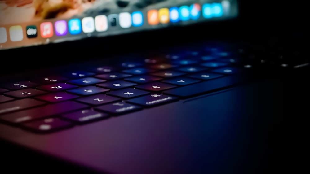 a close up of a laptop keyboard with a blurry background