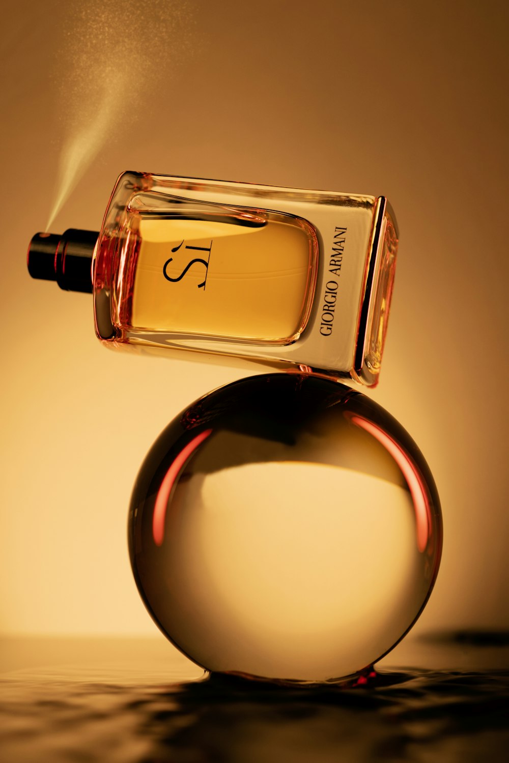 a bottle of perfume sitting on top of a round object