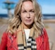 a woman wearing a red jacket and scarf