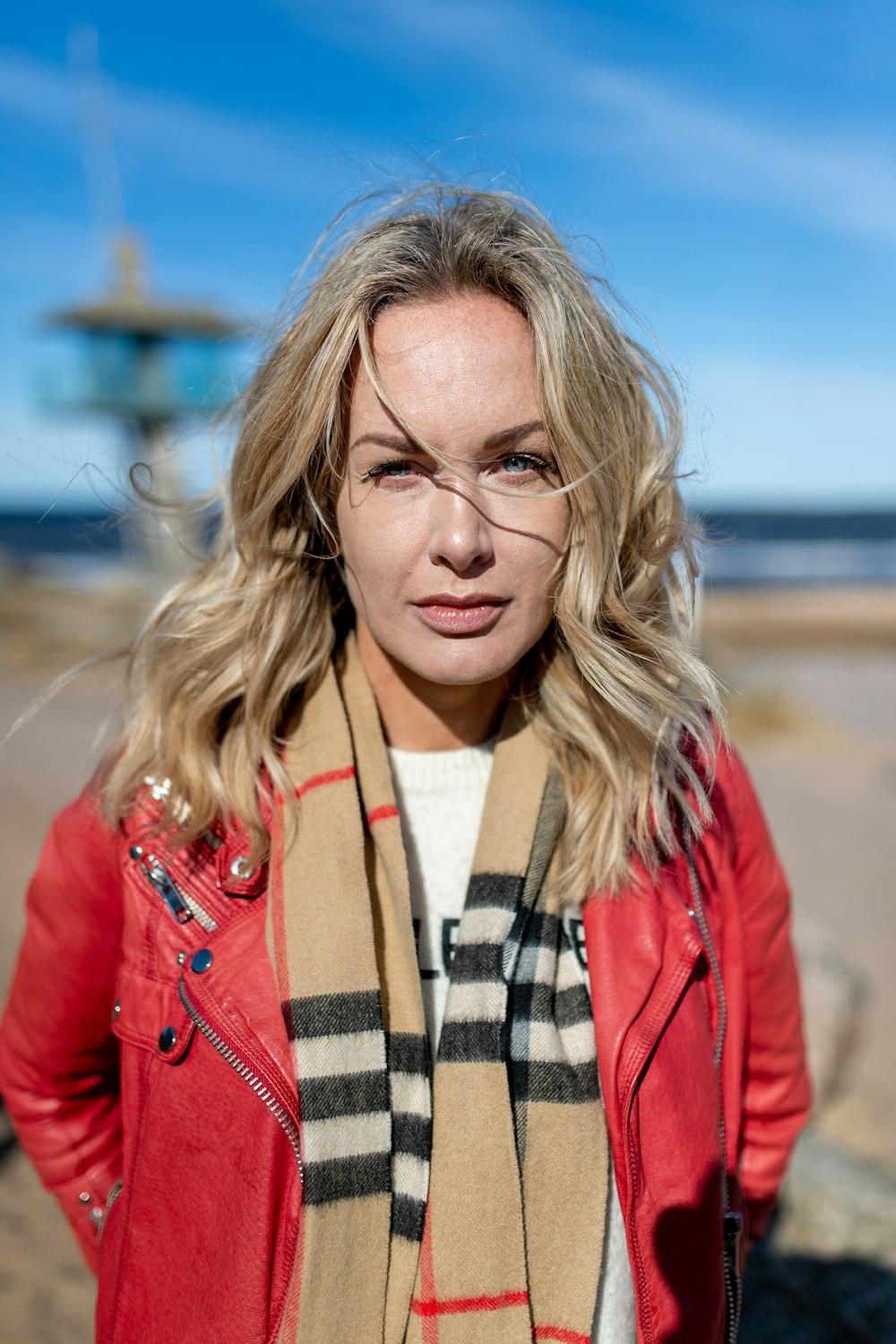 a woman wearing a red jacket and scarf