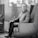 A smiling man sitting in a cozy living room.