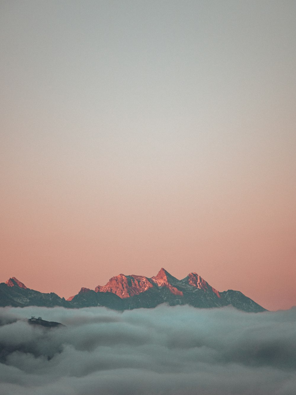 a view of a mountain covered in clouds