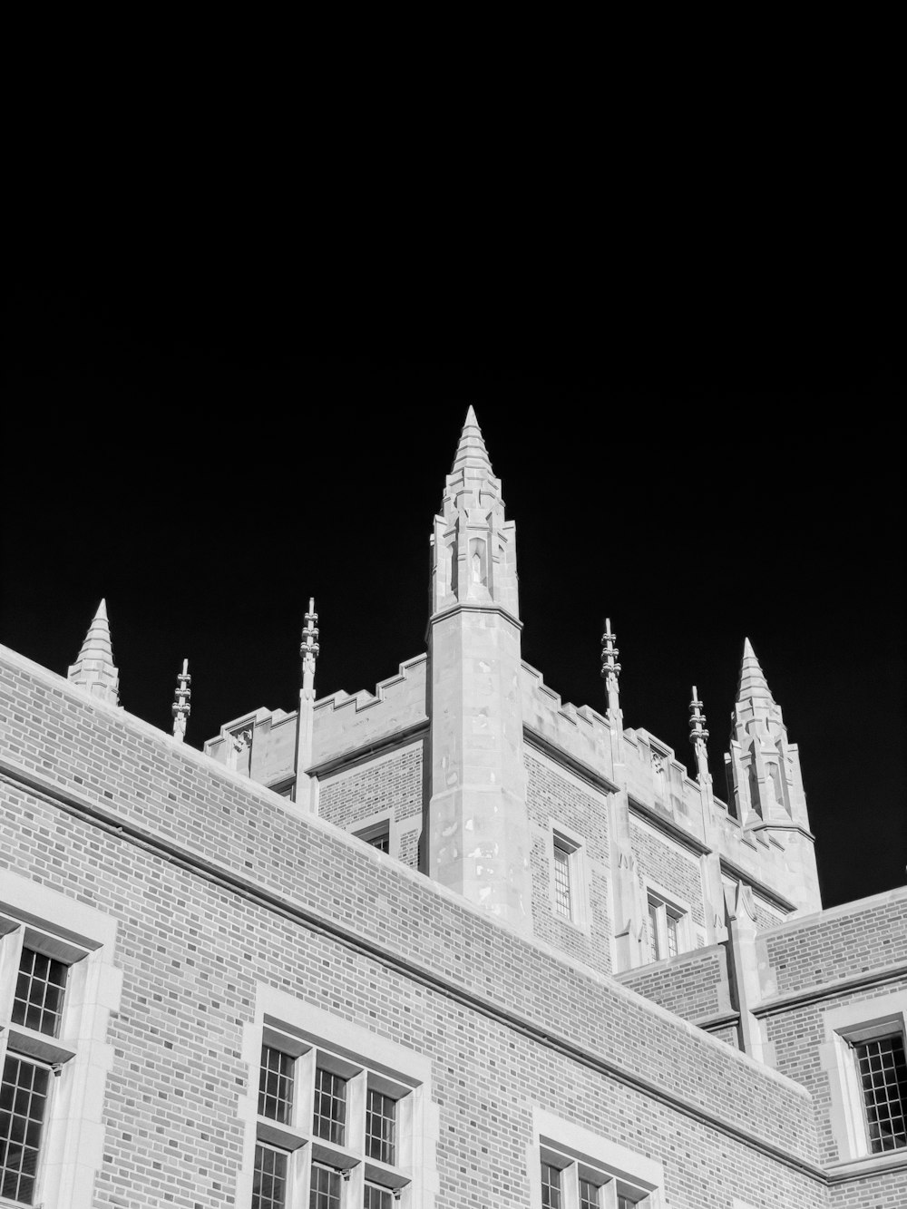 a black and white photo of a building with a clock tower