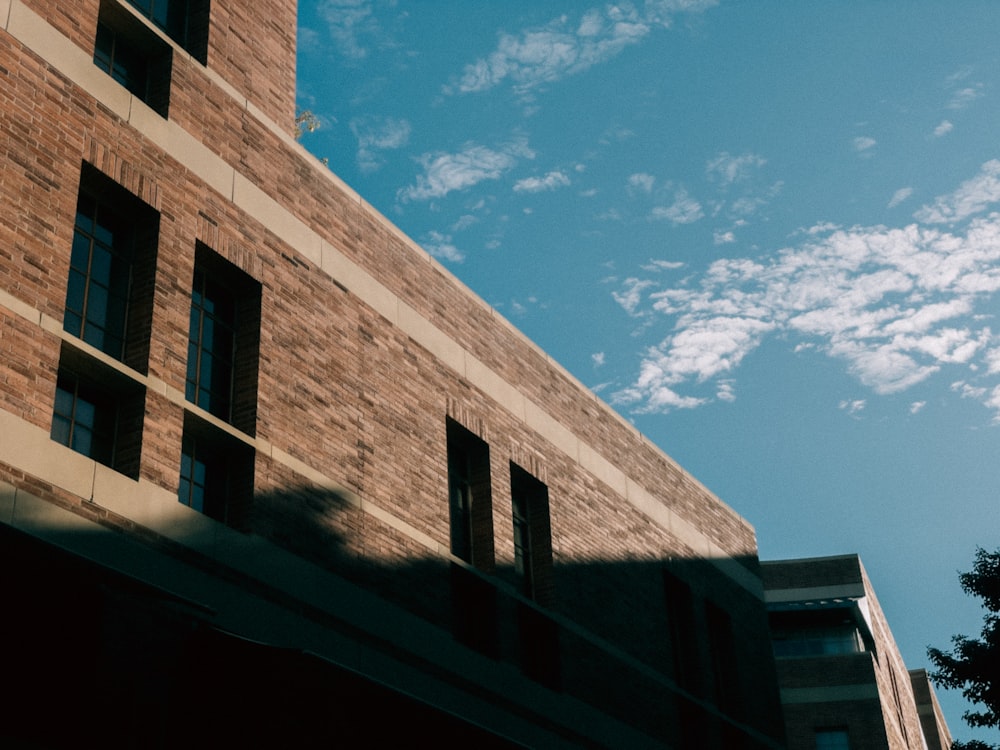 a tall brick building sitting next to a tall building