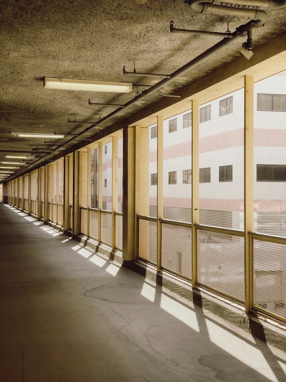 a long hallway lined with windows next to a building