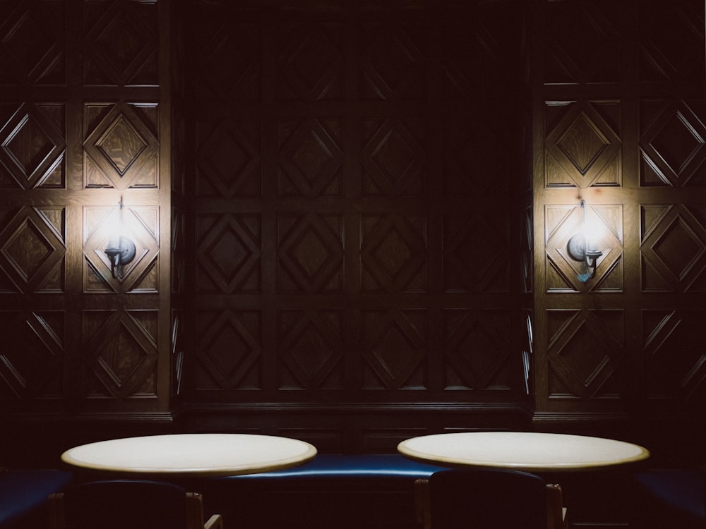 a couple of white tables sitting next to each other