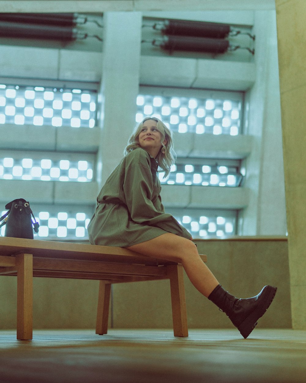 a woman sitting on a bench in a building