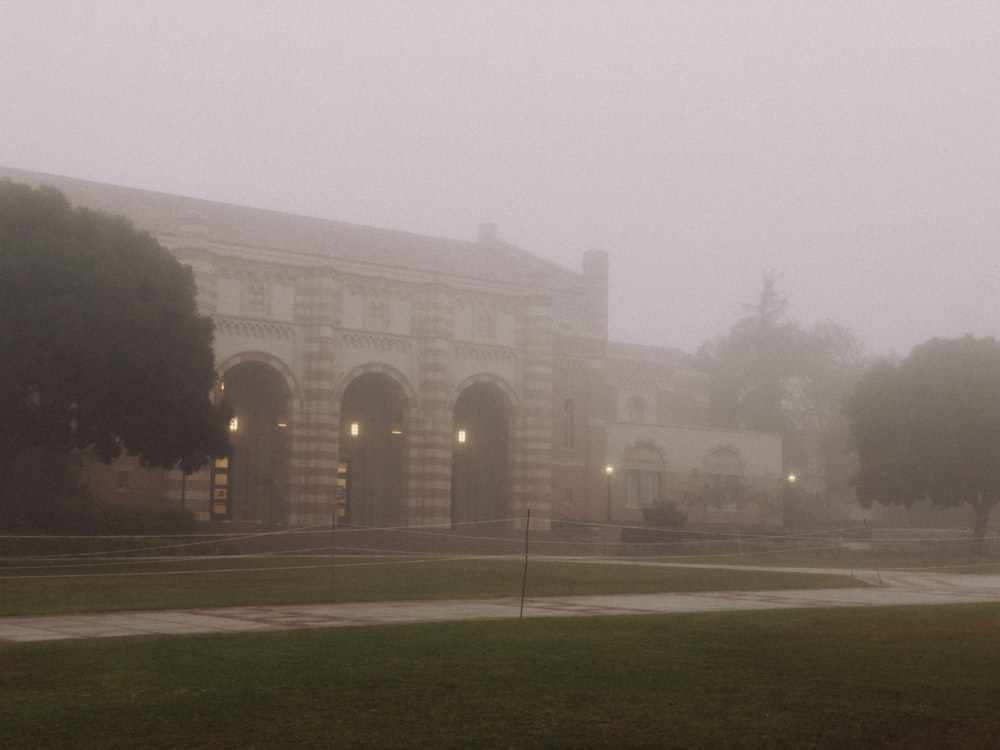 a large building with a clock tower on a foggy day
