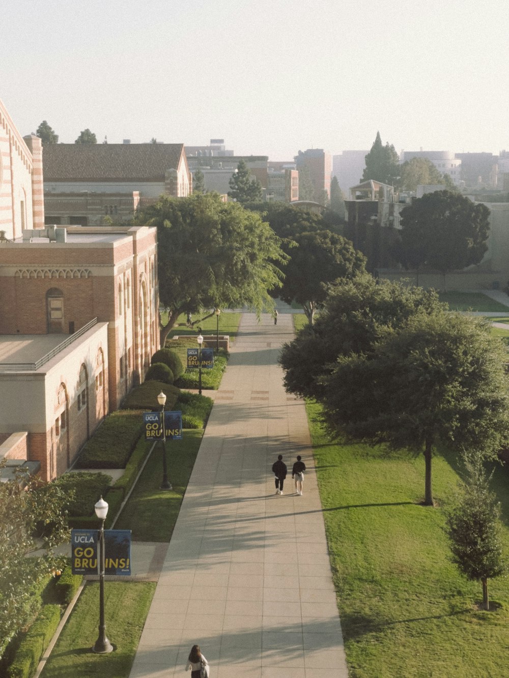 a couple of people walking down a sidewalk