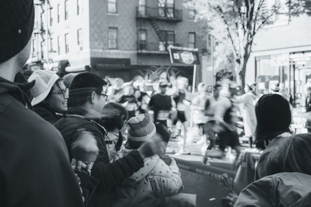 A vibrant photo of runners sprinting through a city park during a sunny 5k race.