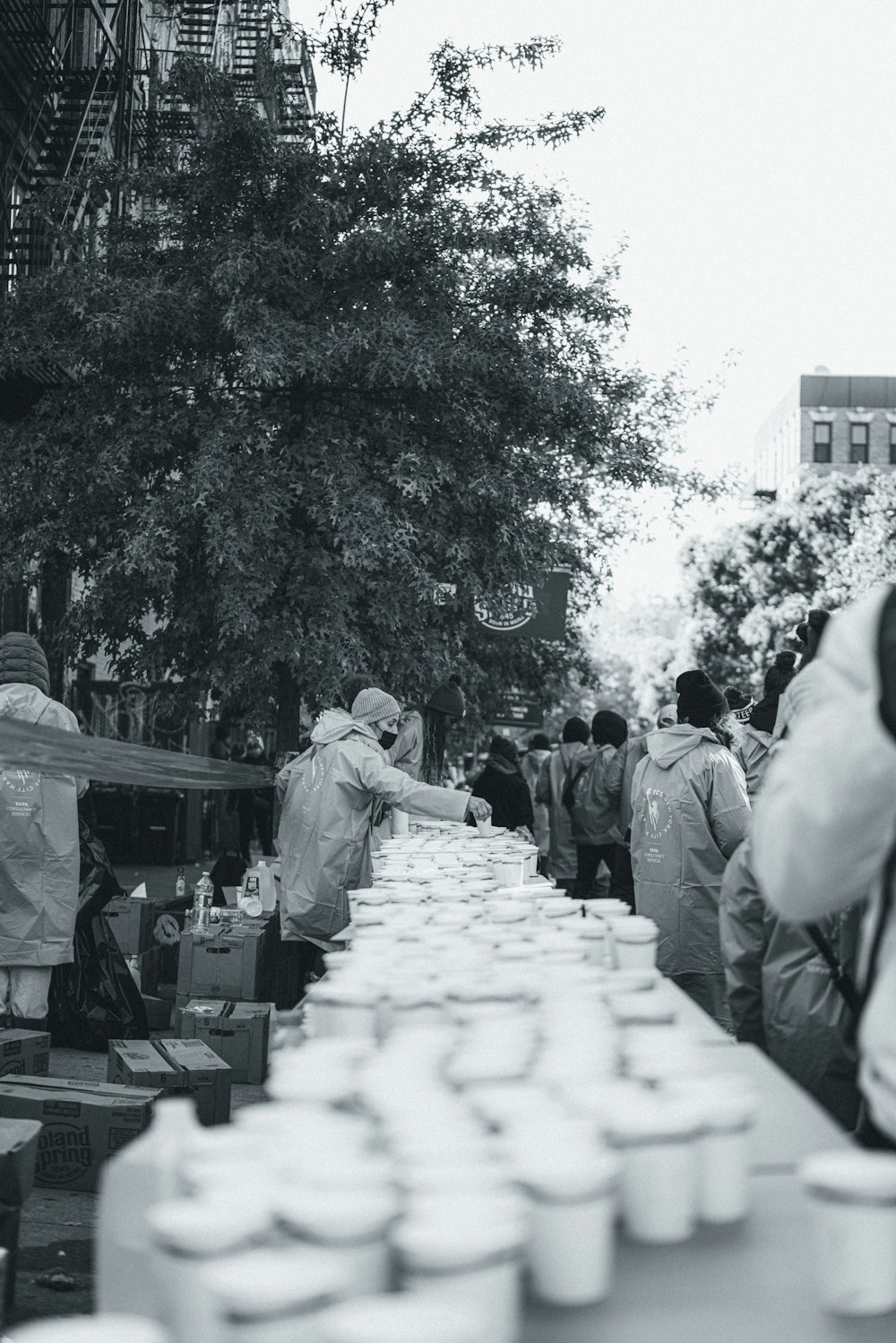 a group of people standing around a long table