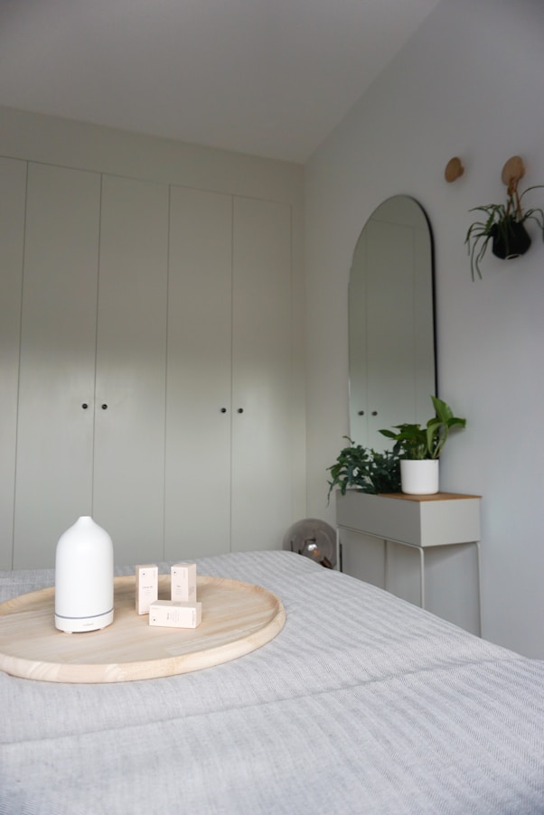 a bed with a wooden tray on top of it