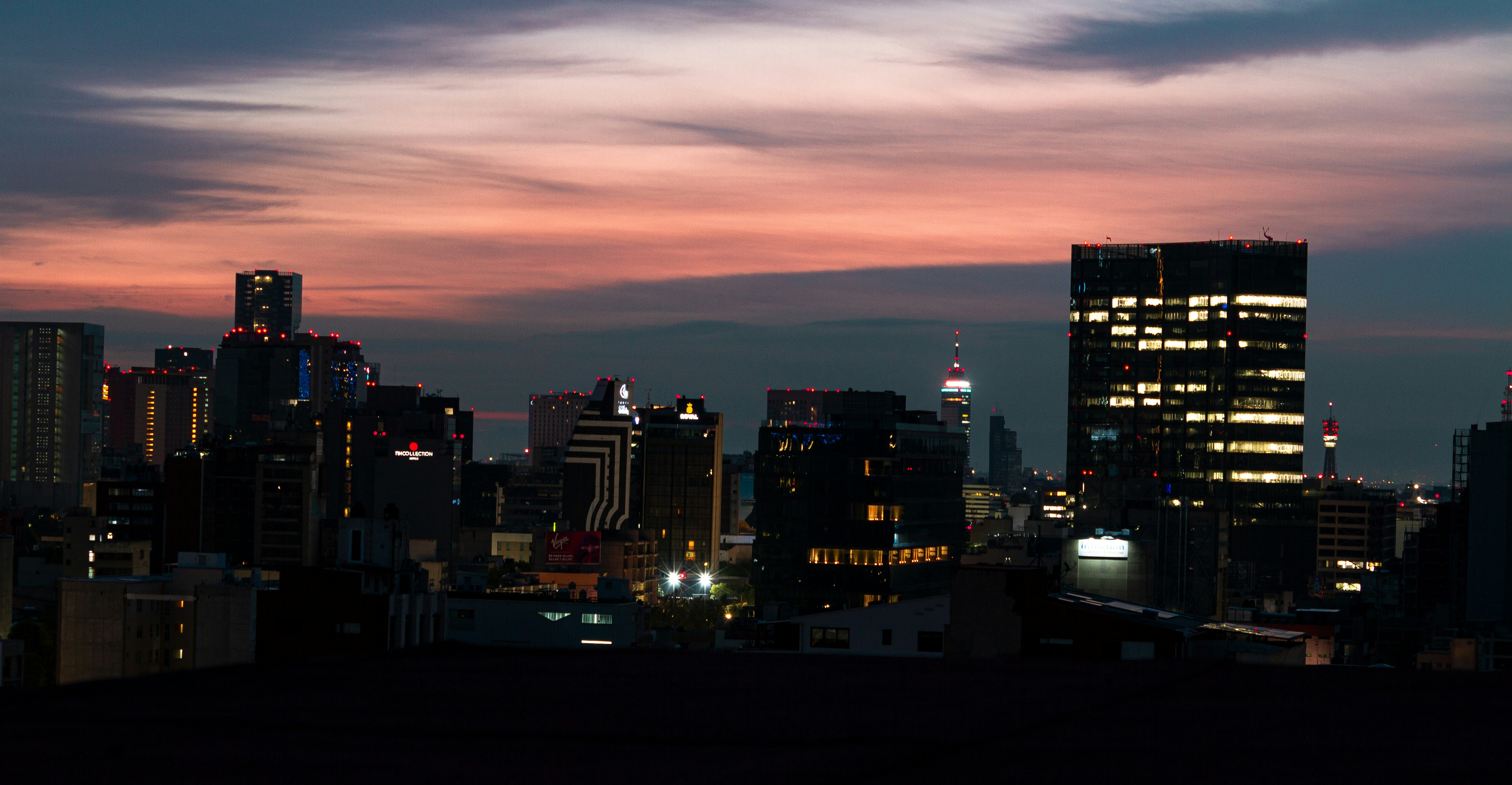 a view of a city at night from a rooftop