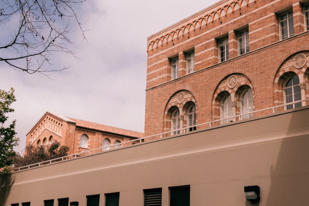 a tall brick building with a clock on it's side