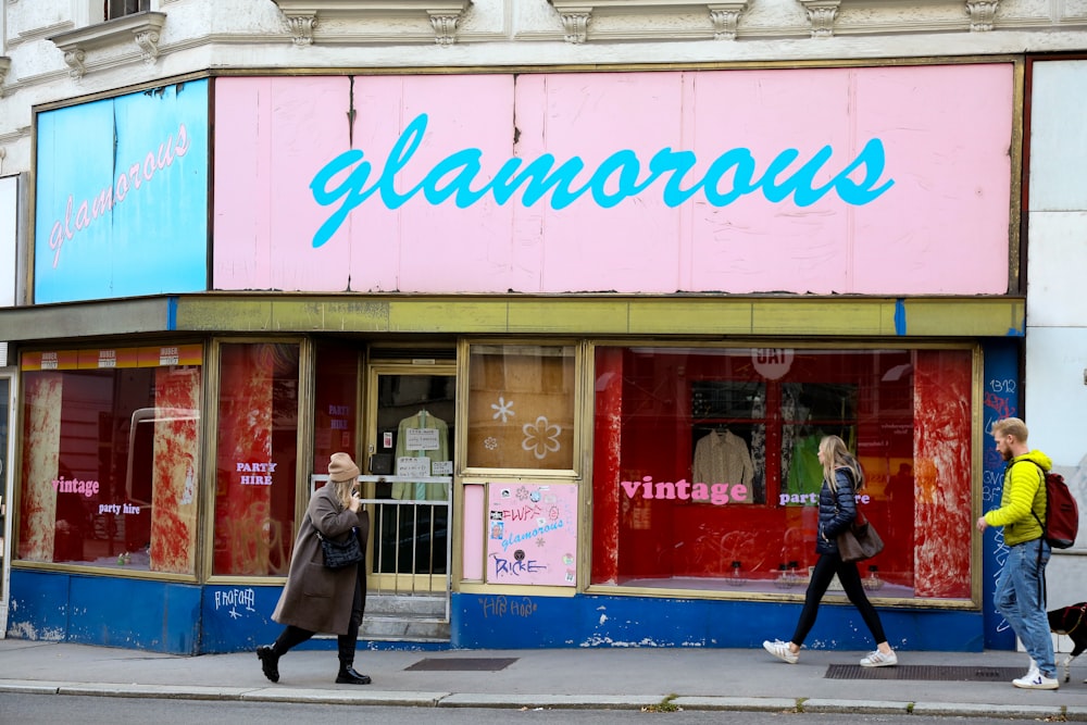 a group of people walking past a store front