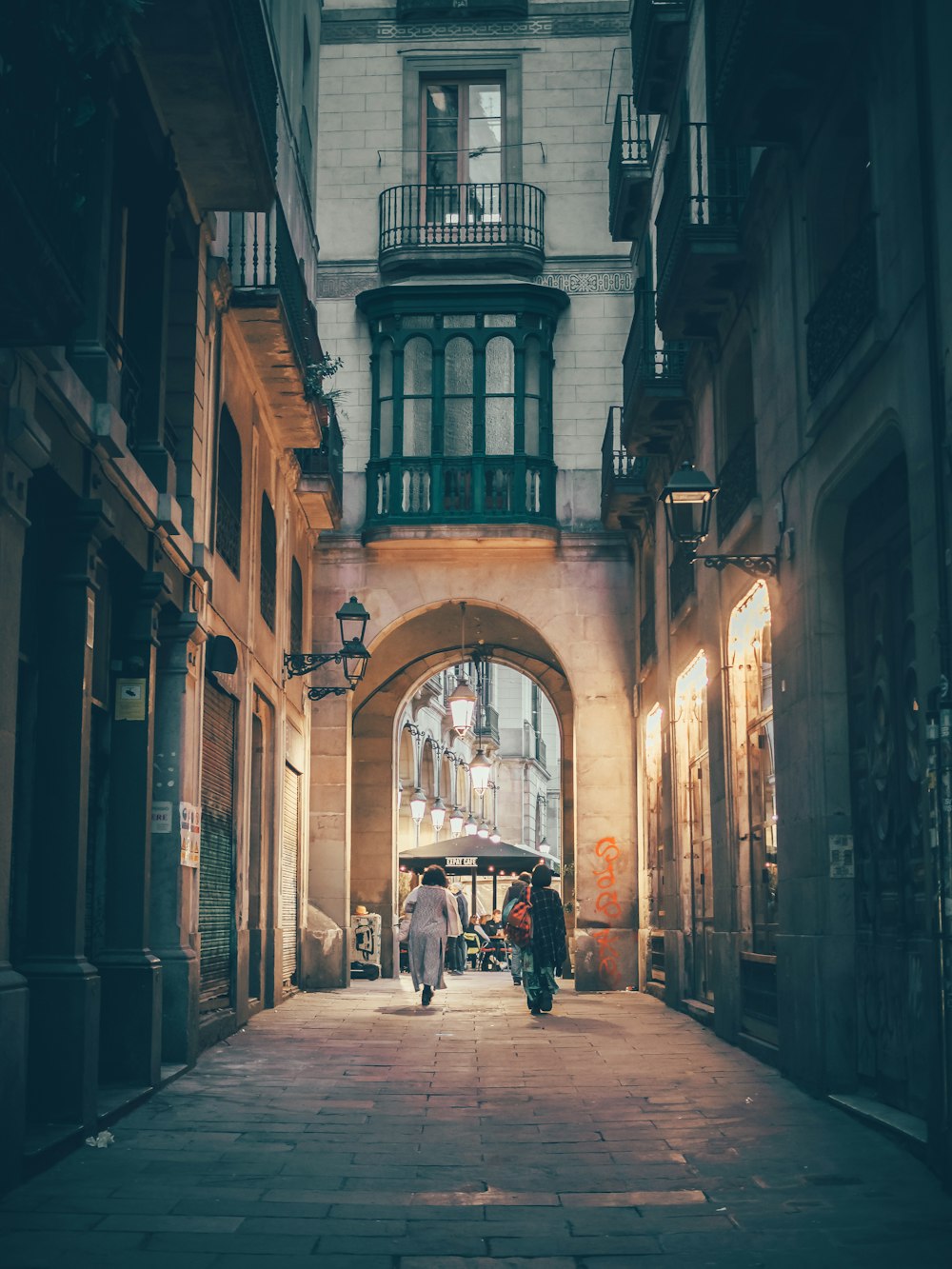 a person walking down an alley way in a city