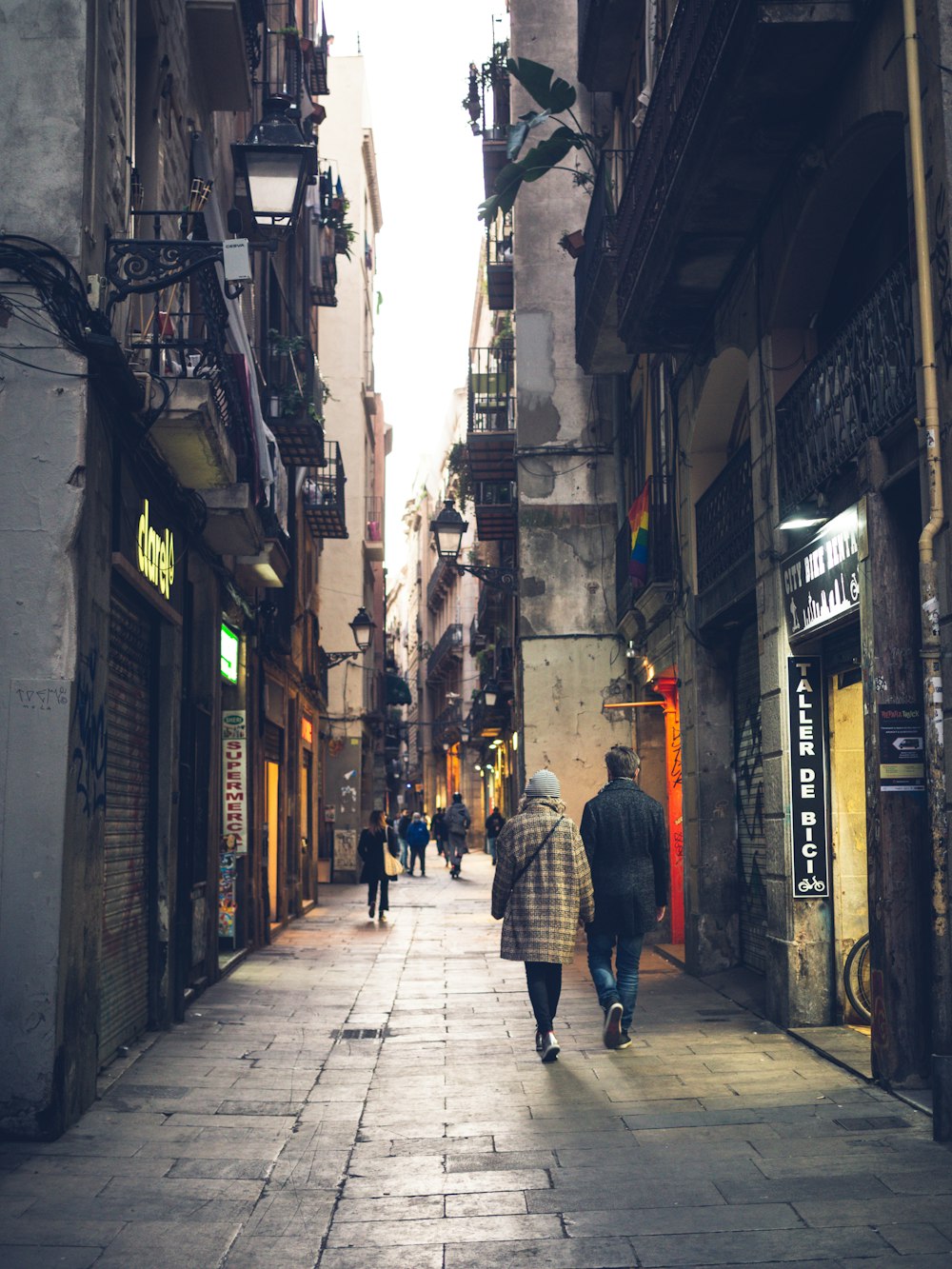 a couple of people that are walking down a street