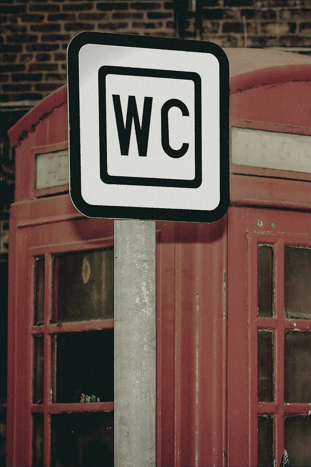 a white and black street sign sitting on top of a metal pole