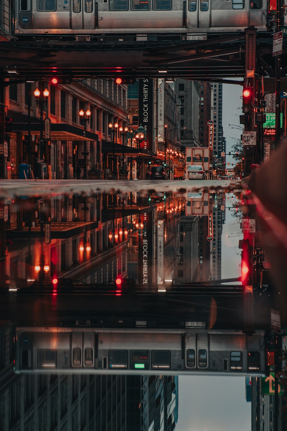 a city street filled with lots of traffic next to tall buildings