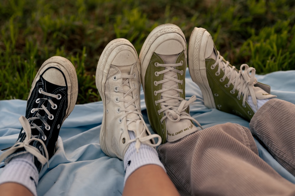 a couple of people sitting on top of a blue blanket