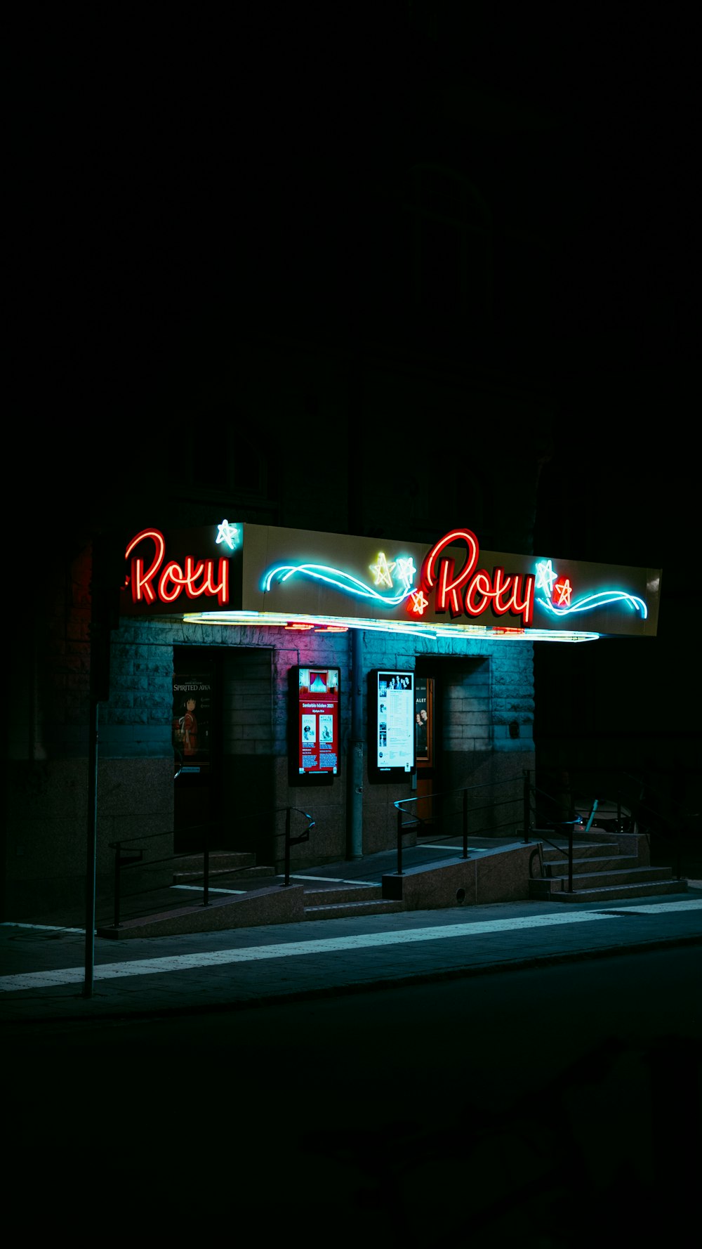 a building with a neon sign on the front of it