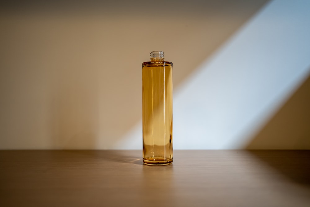 a brown bottle sitting on top of a wooden table