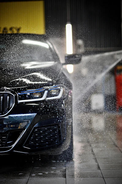 a car is being sprayed with water by a sprayer