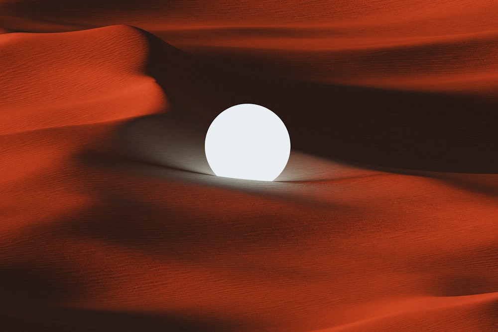 Une boule blanche assise au milieu d’un désert