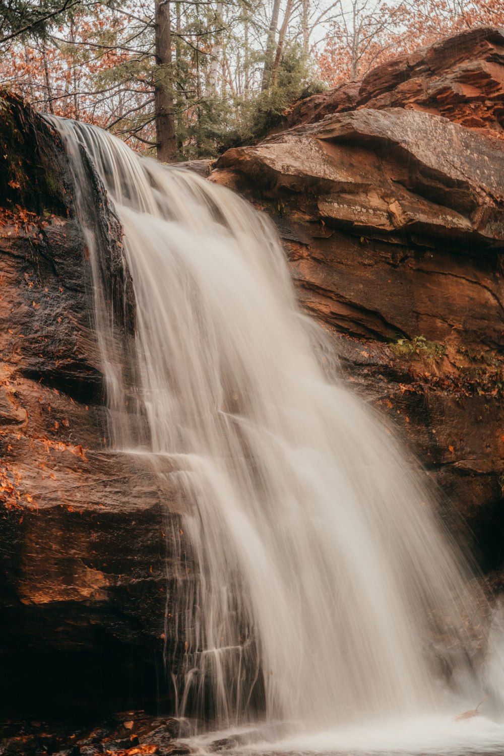 a waterfall with water cascading down it's sides