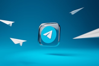 A prominent Telegram app logo is set in the center against a vibrant blue background, surrounded by four minimalist paper airplane illustrations, suggesting themes of communication and connectivity.