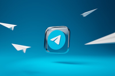 A prominent Telegram app logo is set in the center against a vibrant blue background, surrounded by four minimalist paper airplane illustrations, suggesting themes of communication and connectivity.
