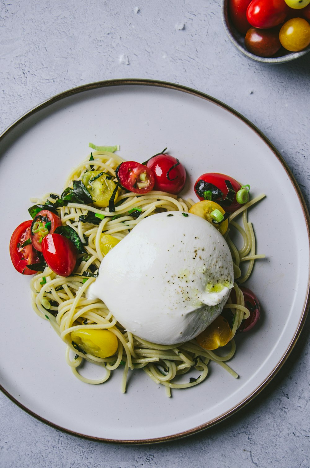 a plate of spaghetti with a poached egg on top