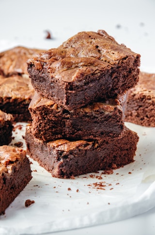 a pile of brownies sitting on top of a white plate