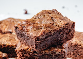 a pile of brownies sitting on top of a white plate