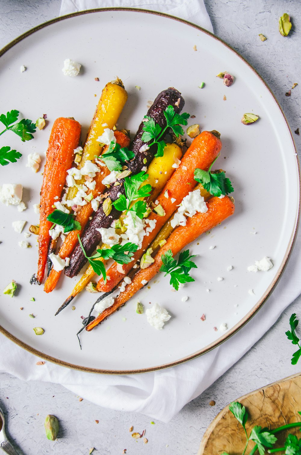 a white plate topped with carrots and feta cheese