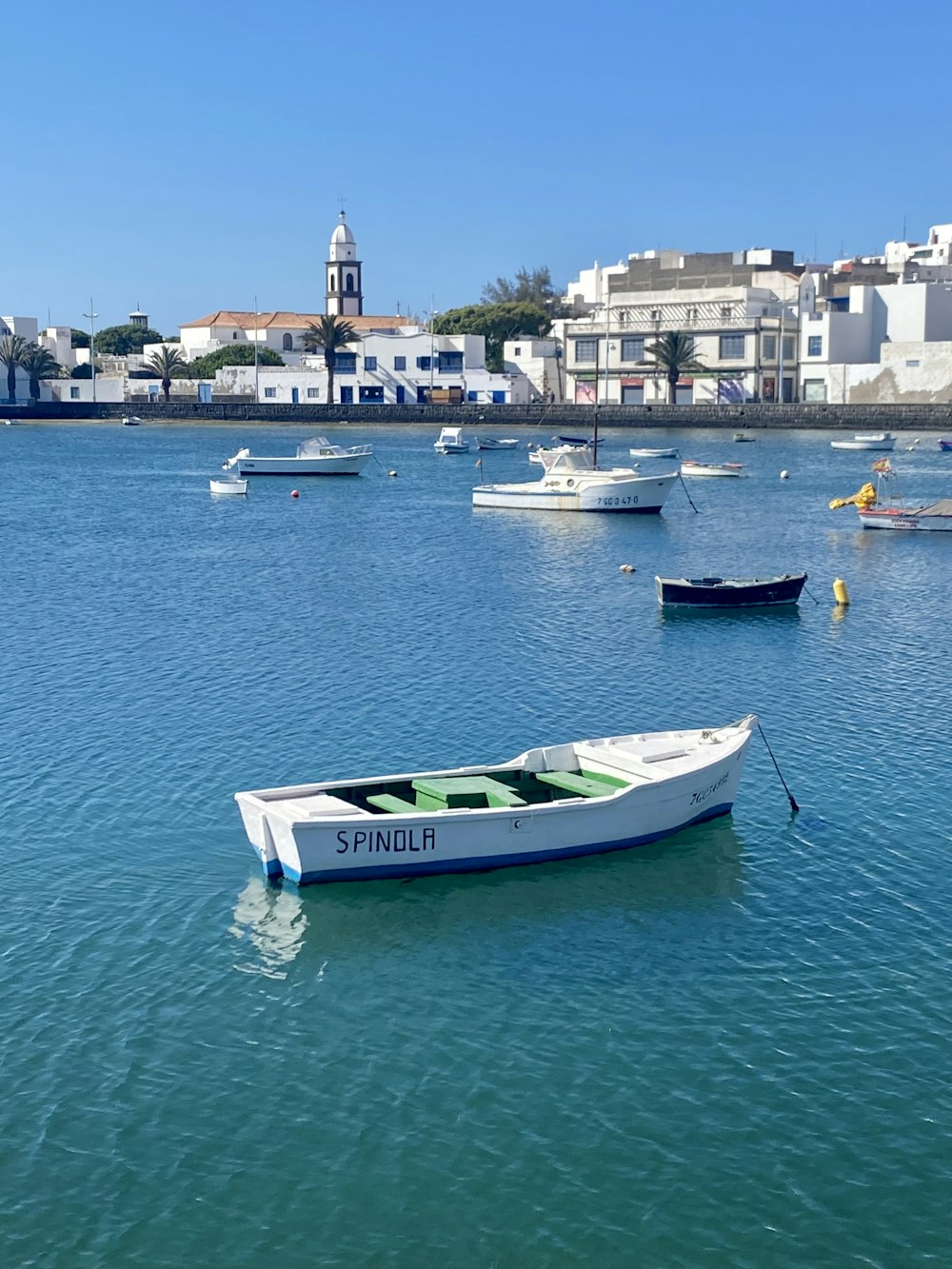 a white boat floating on top of a body of water