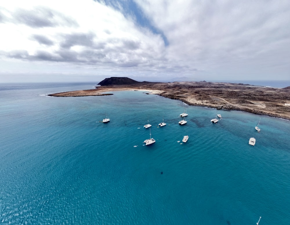 a group of boats floating on top of a body of water