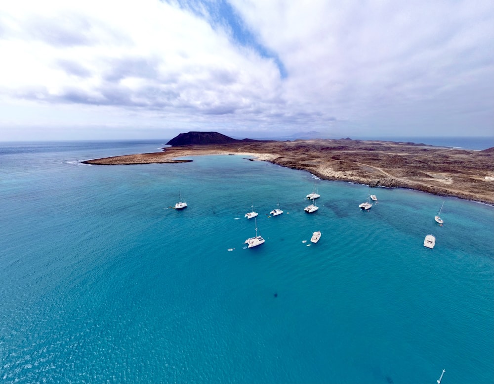 a group of boats floating on top of a body of water