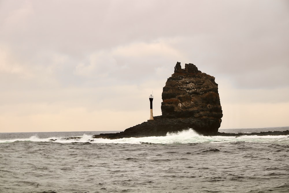 a rock outcropping in the middle of the ocean