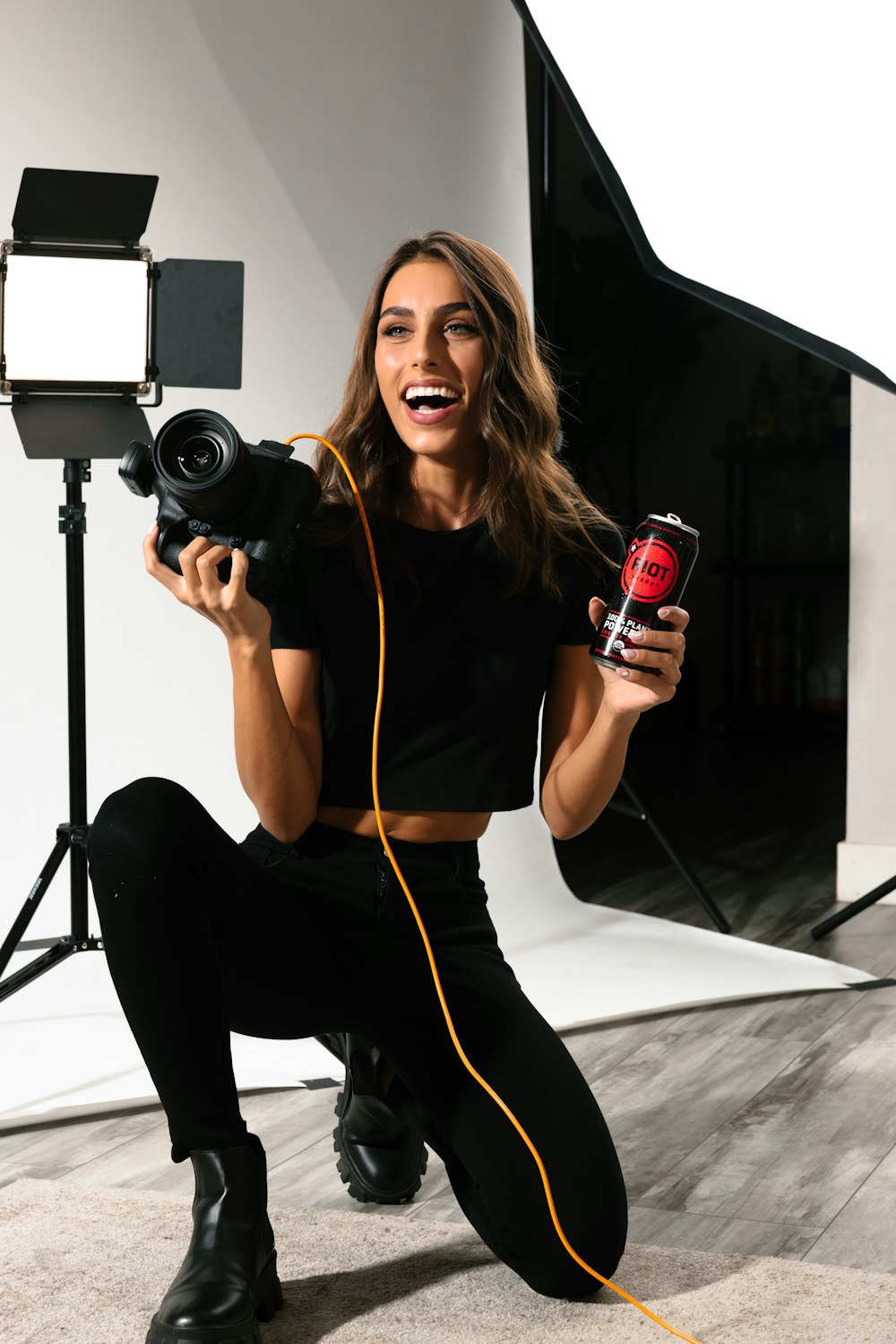 a woman holding a camera and recording a video