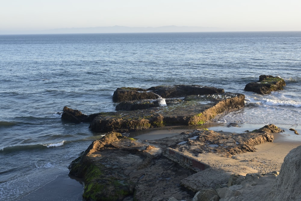 a view of the ocean from a rocky shore