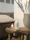 A bright, cozy living room with a vibrant ceramic fragrance diffuser glowing softly on a wooden table.