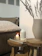 A serene living room softly lit with candles and a diffuser emitting gentle mist.